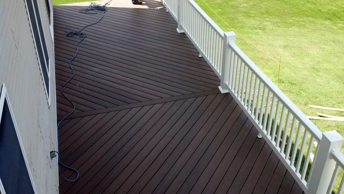 Deck after rebuild — composite decking with white vinyl railing