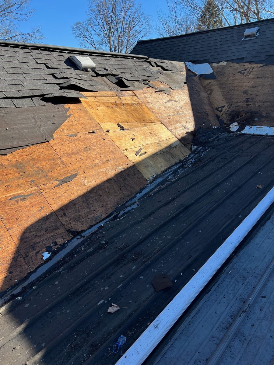 Roof before rebuild — tear-off exposing soaked, delaminated decking