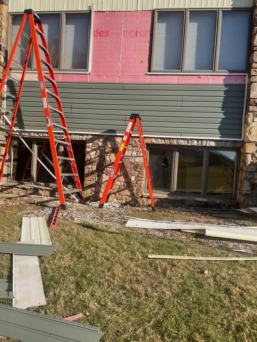 Siding before replacement — stripped back to the housewrap