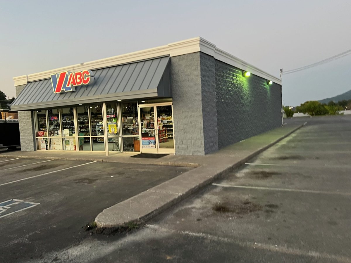 Retail storefront after repaint — charcoal walls and dark awning